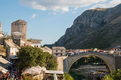 Arch bridge over buildings in city