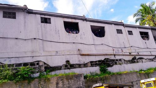 Low angle view of abandoned building against sky