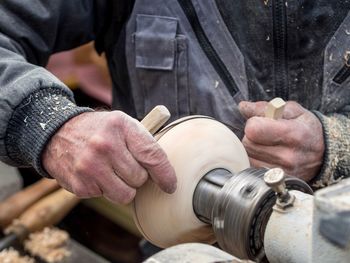 Midsection of man using machinery