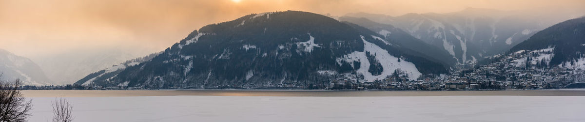 Panoramic view of lake and mountains against sky during sunset