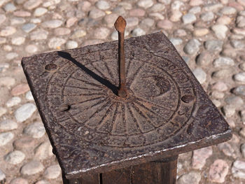 Close-up of clock against stone wall