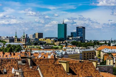 View of cityscape against cloudy sky