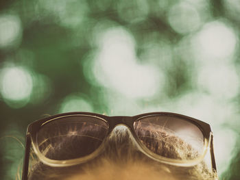 Close-up of sunglasses against sky