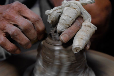 Cropped hand making pot