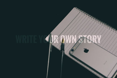 Low angle view of text on building against sky at night