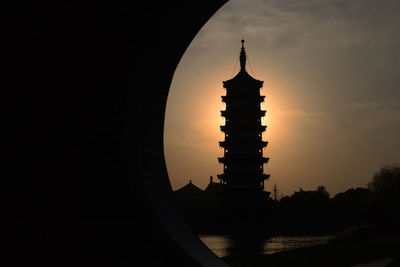 Silhouette of temple against sky during sunset