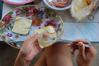 Midsection of woman holding food on table