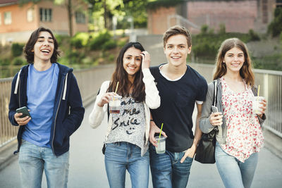 Portrait of a smiling young man holding smart phone