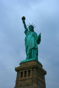 Low angle view of statue against cloudy sky