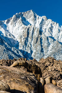 Scenic view of snowcapped mountains against clear sky