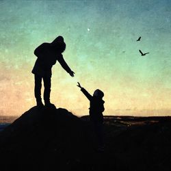 Silhouette men standing against sky during sunset