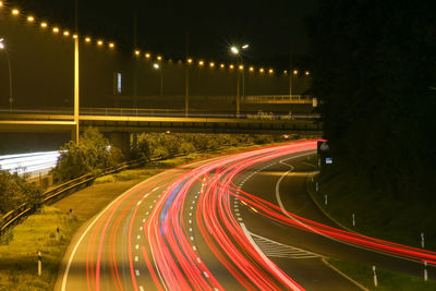 High angle view of light trails on highway at night