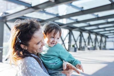 Mother and son on bridge