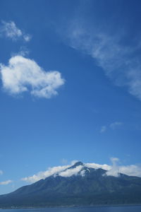 Low angle view of mountains against blue sky