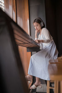 Woman looking away while sitting on seat