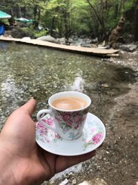 Cropped image of hand holding coffee cup