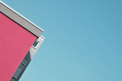 Low angle view of building against clear blue sky