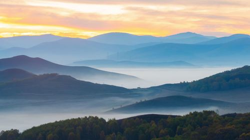 Scenic view of mountains against sky during sunset