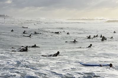 View of people swimming in sea