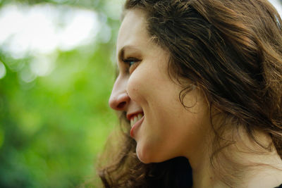 Close-up of smiling young woman looking away