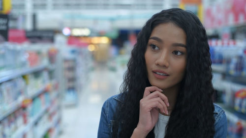 Portrait of smiling young woman in store