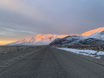 Scenic view of snowcapped mountains against sky during sunrise