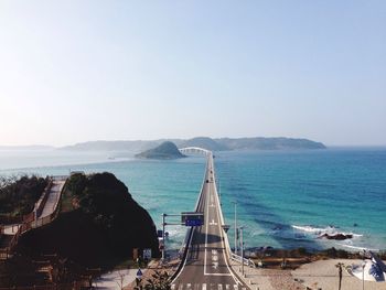 Tsunoshima ohashi bridge over sea against clear sky