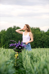 Side view of young woman standing on field