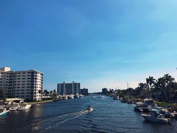 Sea by cityscape against sky