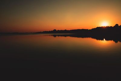 Scenic view of lake against romantic sky at sunset