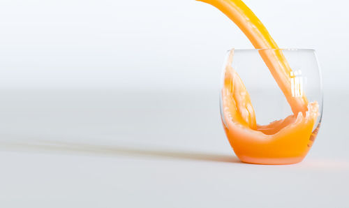 Close-up of orange juice on table