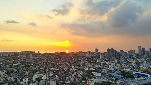 High angle view of city against cloudy sky