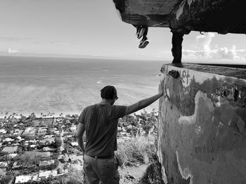 Rear view of man looking at sea