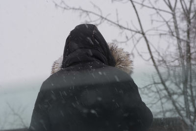 Low section of woman standing on snow