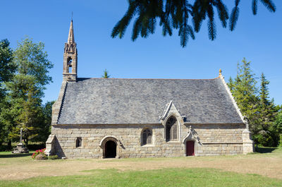 Low angle view of church against blue sky