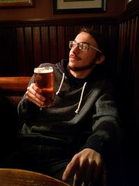 Portrait of young man sitting in pub