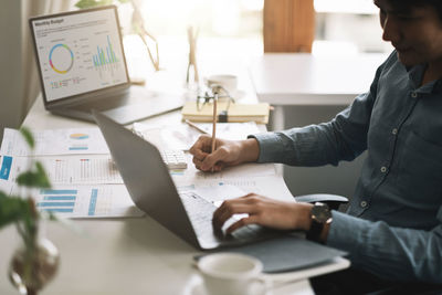 Midsection of business colleagues working at office