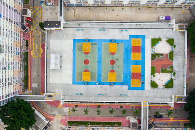 Directly above shot of sports court by buildings in city