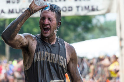 Athlete cooling off after the muddy race