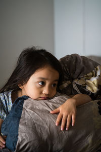 Cute girl relaxing on bed at home