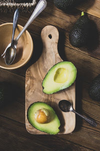 High angle view of fruits and cutting board on table