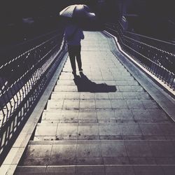 Full length of woman standing on steps