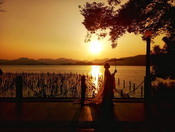 Scenic view of lake against sky during sunset