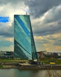 Skyscrapers against cloudy sky