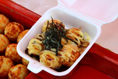 Close-up of sushi and takoyaki balls