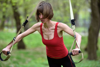 Mid adult woman exercising at public park