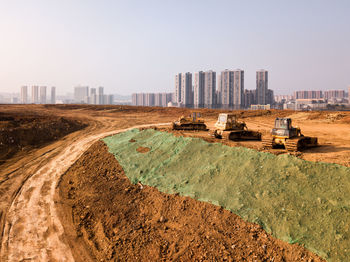 Construction site in city against clear sky