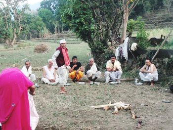 Group of people relaxing on land