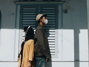 Woman standing against wall