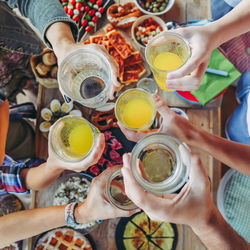 Toast with friends dinner enjoying together friends aperitif  top view of  glasses in hands cheer up